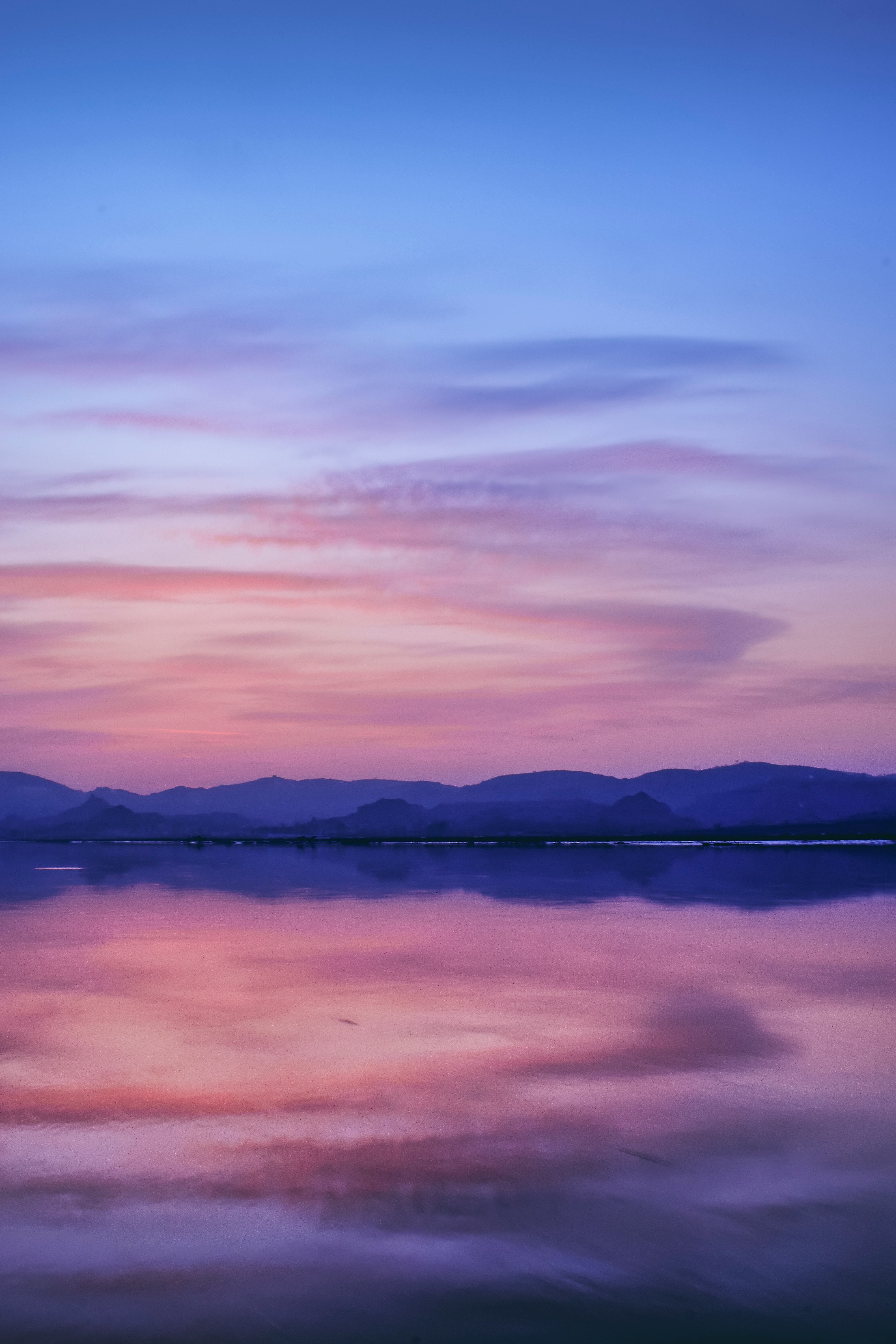 reflection of mountain on body of water